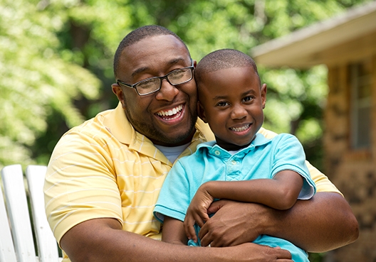 Somesa Education Plan dad hugging son